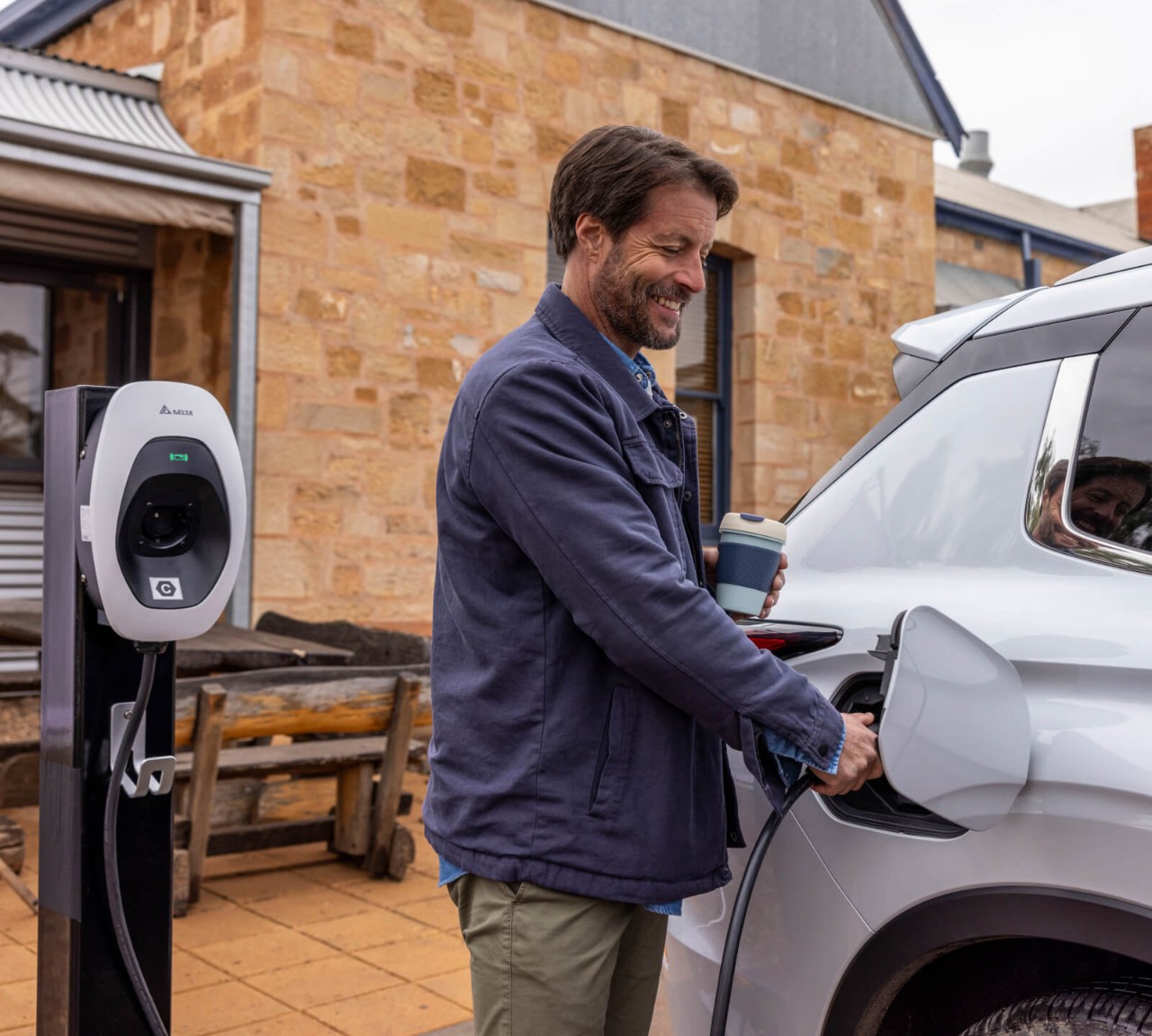 Man charging Mitsubishi Outlander PHEV